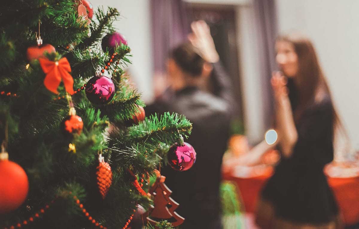 decorated christmas tree with blurred people in the background
