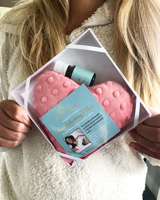 a person holding an essential oils gift box